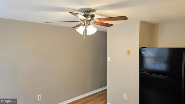 a view of a hallway with a refrigerator