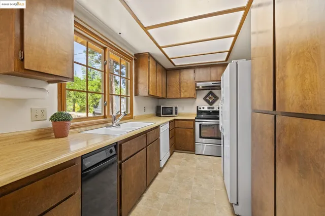a very nice looking dining room with a large window and chandelier