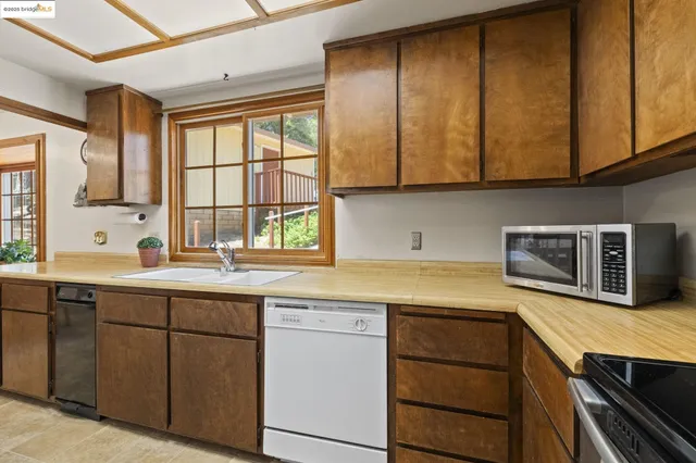 a kitchen with stainless steel appliances a stove and a microwave