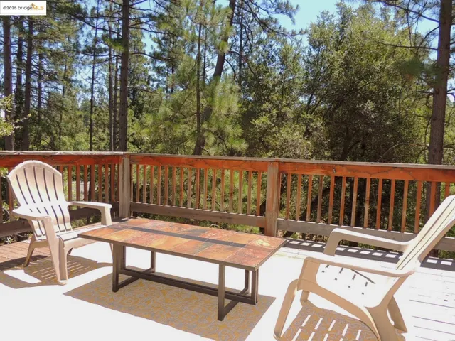 a view of a patio with two chairs and a table