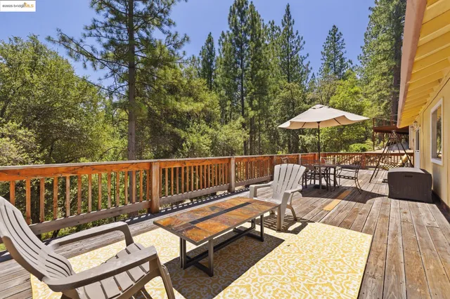 a balcony with furniture and wooden floor