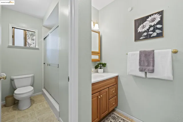 a spacious bathroom with a toilet a sink and mirror