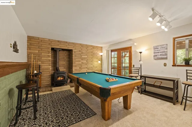 a bedroom with a bed and a lamp on dresser