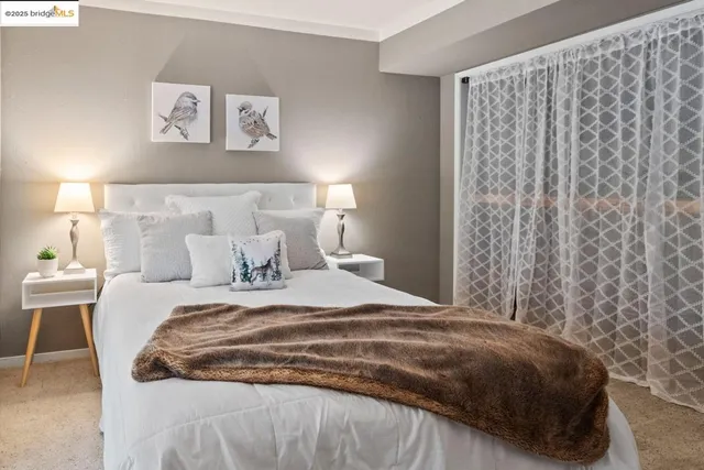 a bedroom with a bed and a night stand