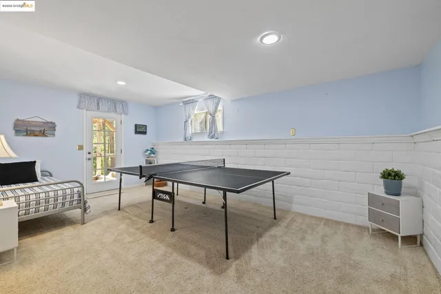 an aerial view of residential house with outdoor space and trees all around