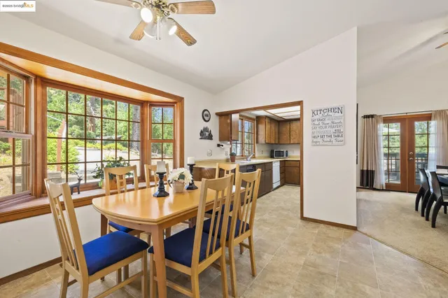 a living room with furniture a dining table and kitchen view