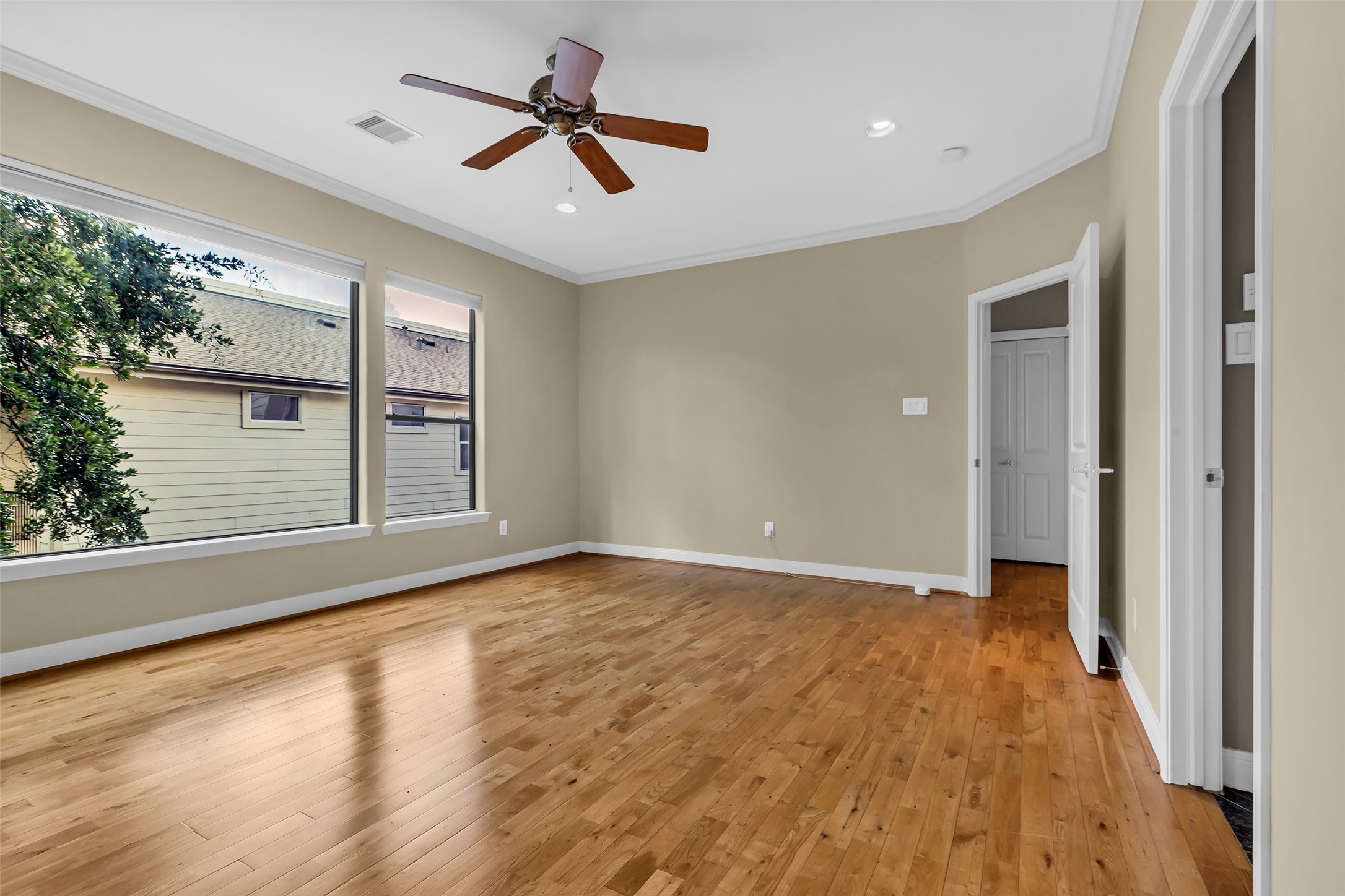 2413 Ralph Street, Unit 2 Houston, TX 77006 - Photo 11 of 26 an empty room with wooden floor and windows
