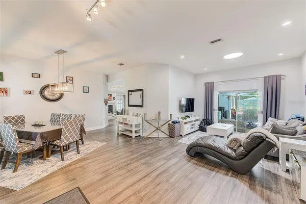 a living room with furniture and wooden floor