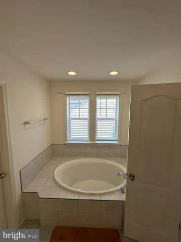 a bathroom with a toilet and a window
