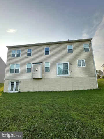 a view of a town with couple of cars parked in front of it