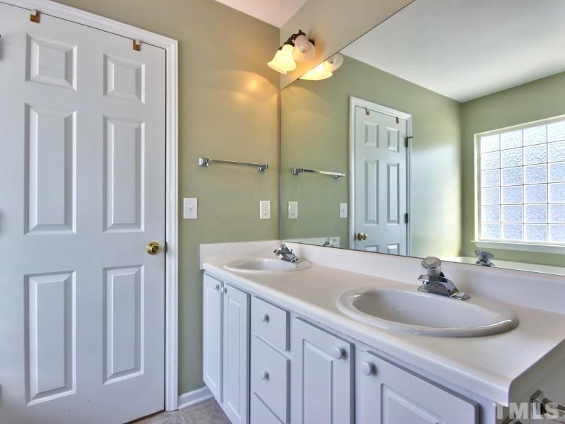 4221 Hopper Street Raleigh, NC 27616 - Photo 14 of 25 a bathroom with a sink and a mirror