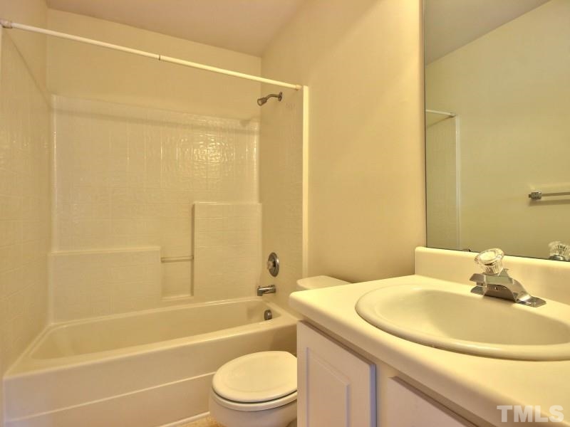 4221 Hopper Street Raleigh, NC 27616 - Photo 22 of 25 a bathroom with a sink a toilet and a bathtub