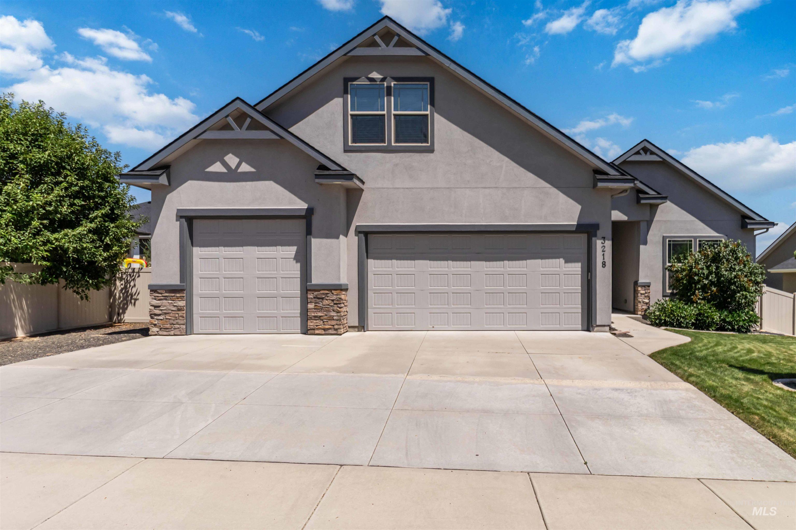 3218 North Cherry Laurel Way Star, ID 83669 - Photo 3 of 50 Stucco exterior with stone accents and a multi-car driveway