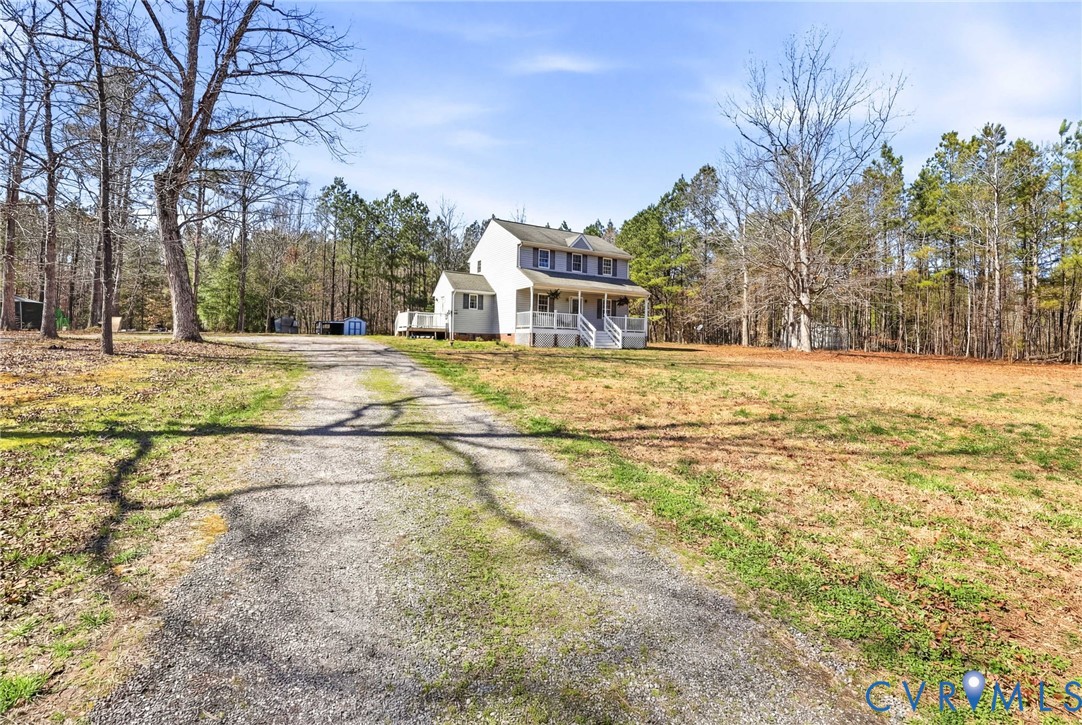 a view of a house with a yard and trees