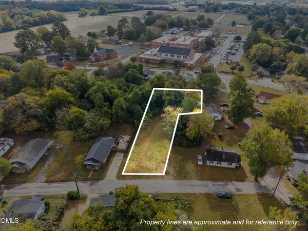 an aerial view of a pool with a yard