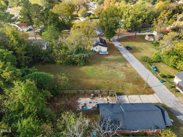 an aerial view of residential houses with yard