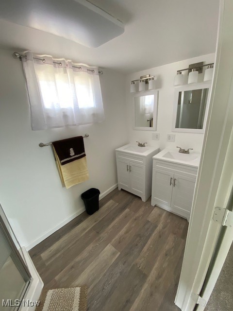 71056 Morristown Flushing Road Flushing, OH 43977 - Photo 13 of 15 Bathroom with two vanities, dark wood-type flooring, and a stall shower