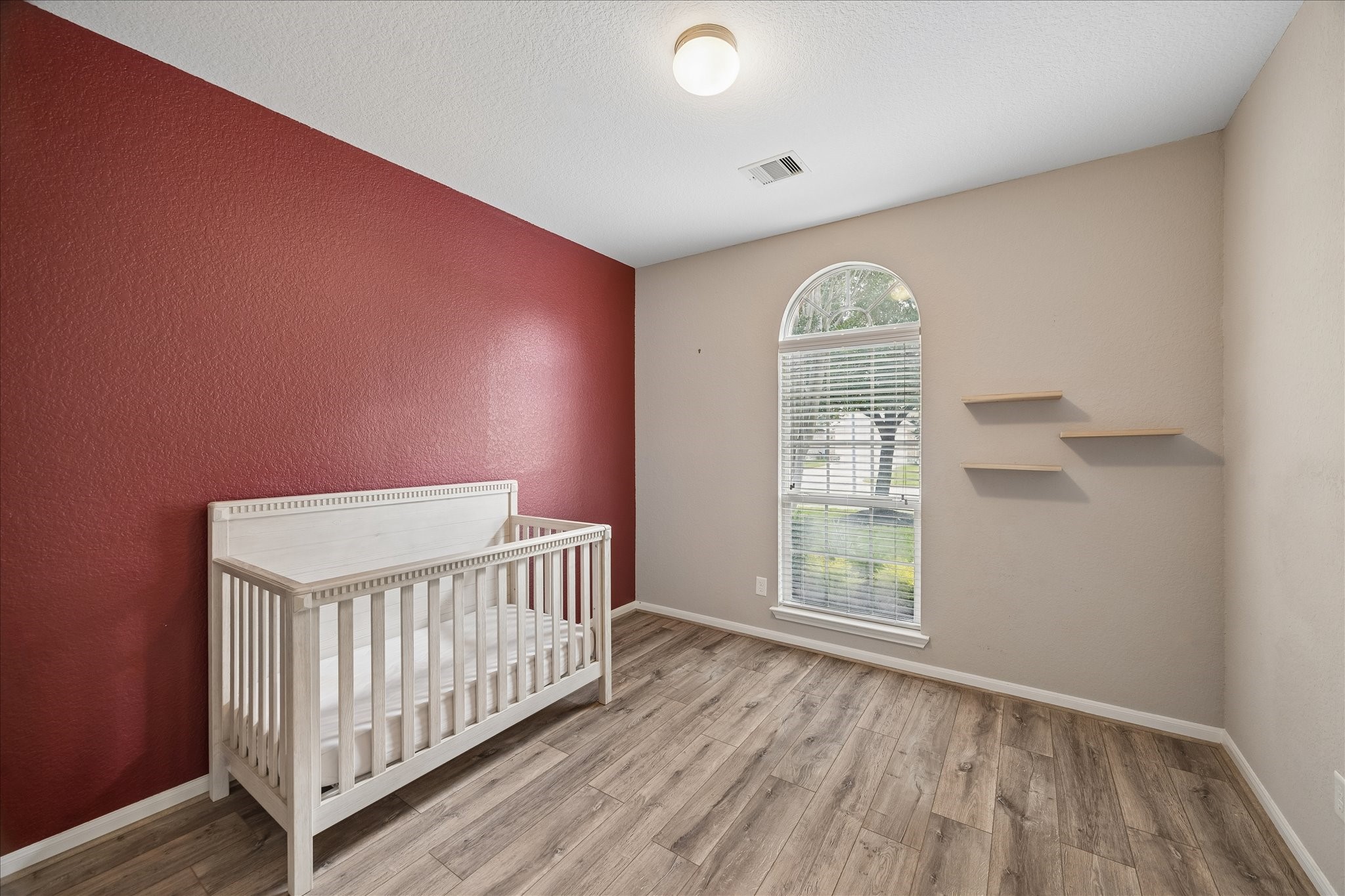 13006 Millstream Bend Lane Tomball, TX 77377 - Photo 16 of 25 an empty room with wooden floor fan and windows