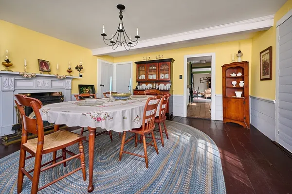 a dining room with furniture a chandelier and wooden floor
