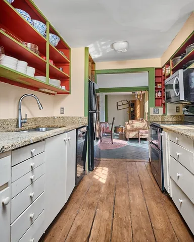 a kitchen with granite countertop stainless steel appliances and cabinets