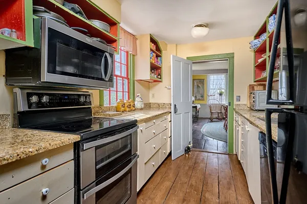 a kitchen with stainless steel appliances a stove microwave and cabinets