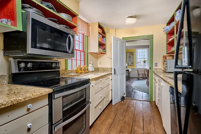 a kitchen with stainless steel appliances a stove microwave and cabinets