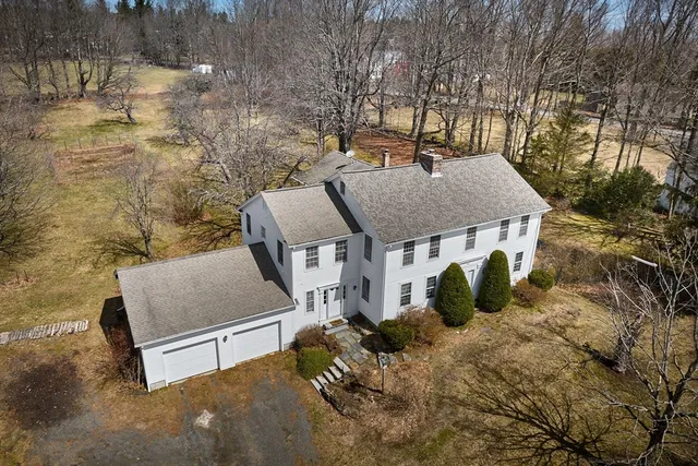 a view of backyard of house with outdoor seating