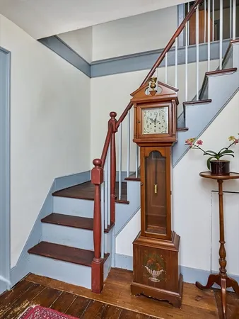 a view of entryway with wooden floor and a front door