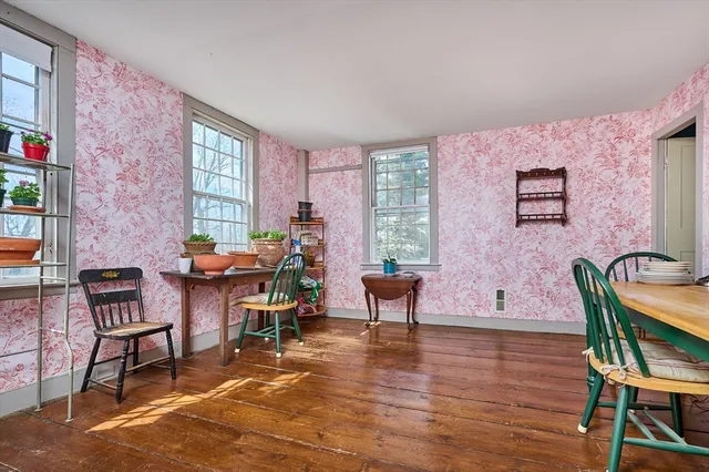 a living room with furniture a rug and a window