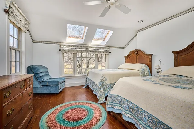 a bedroom with two beds and a large window
