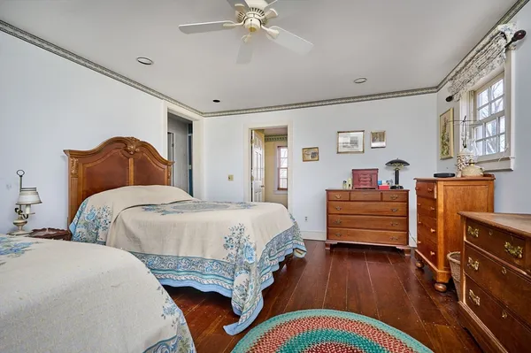 a bedroom with bed and wooden floor