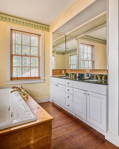 a spacious bathroom with a large tub and sink