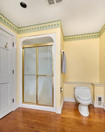 a bathroom with a toilet and a shower