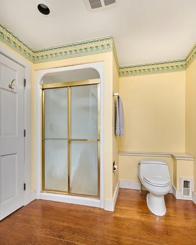 a bathroom with a toilet and a shower