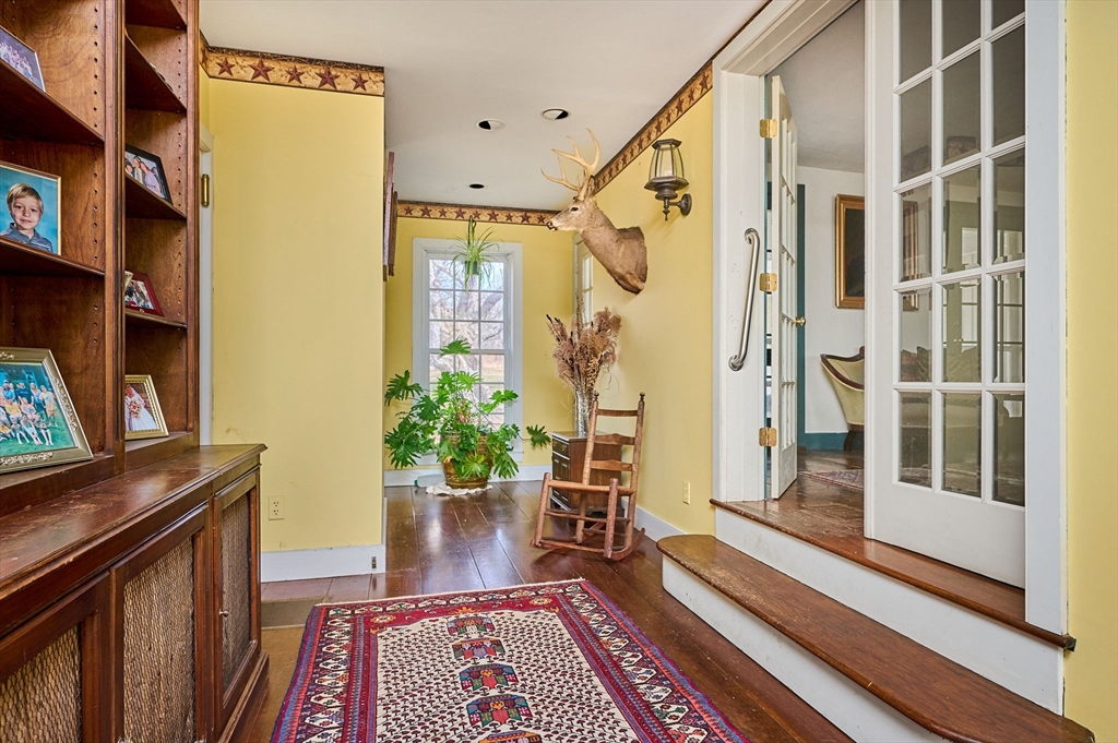 296 Main Street Plainfield, MA 01070 - Photo 5 of 42 a view of a hallway with wooden floor and staircase