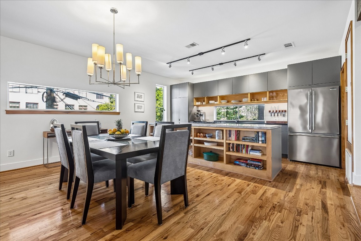 98 Drew Street, Unit A Houston, TX 77006 - Photo 20 of 38 a view of a dining room with furniture a kitchen and chandelier