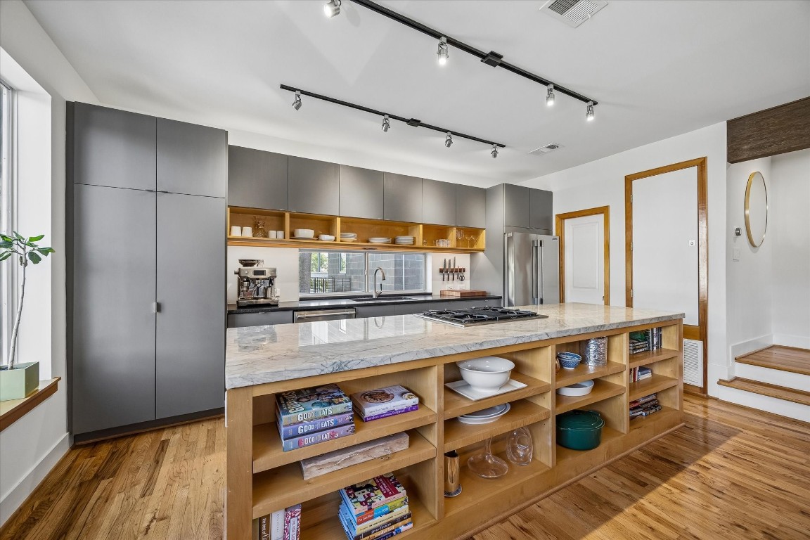 98 Drew Street, Unit A Houston, TX 77006 - Photo 22 of 38 a kitchen with stainless steel appliances granite countertop a stove and a sink