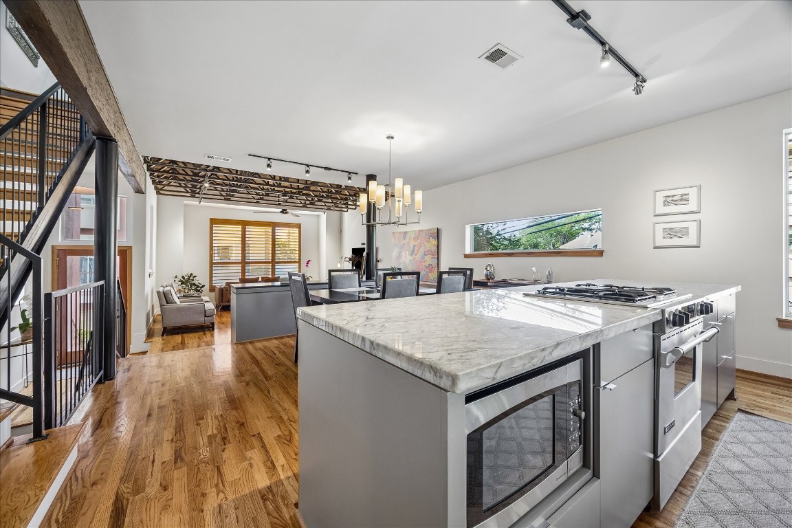98 Drew Street, Unit A Houston, TX 77006 - Photo 24 of 38 a kitchen with a stove and a wooden floors