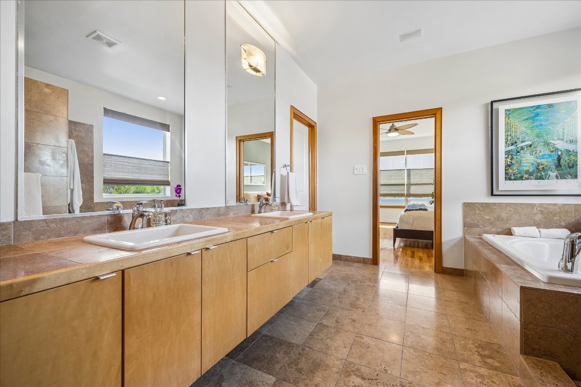 98 Drew Street, Unit A Houston, TX 77006 - Photo 31 of 38 a large bathroom with a large tub and sink