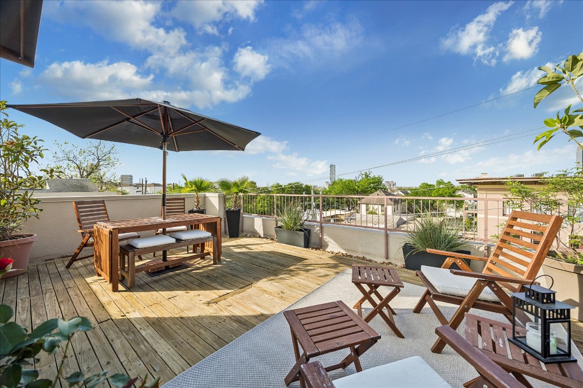 98 Drew Street, Unit A Houston, TX 77006 - Photo 36 of 38 an outdoor space with furniture and umbrella