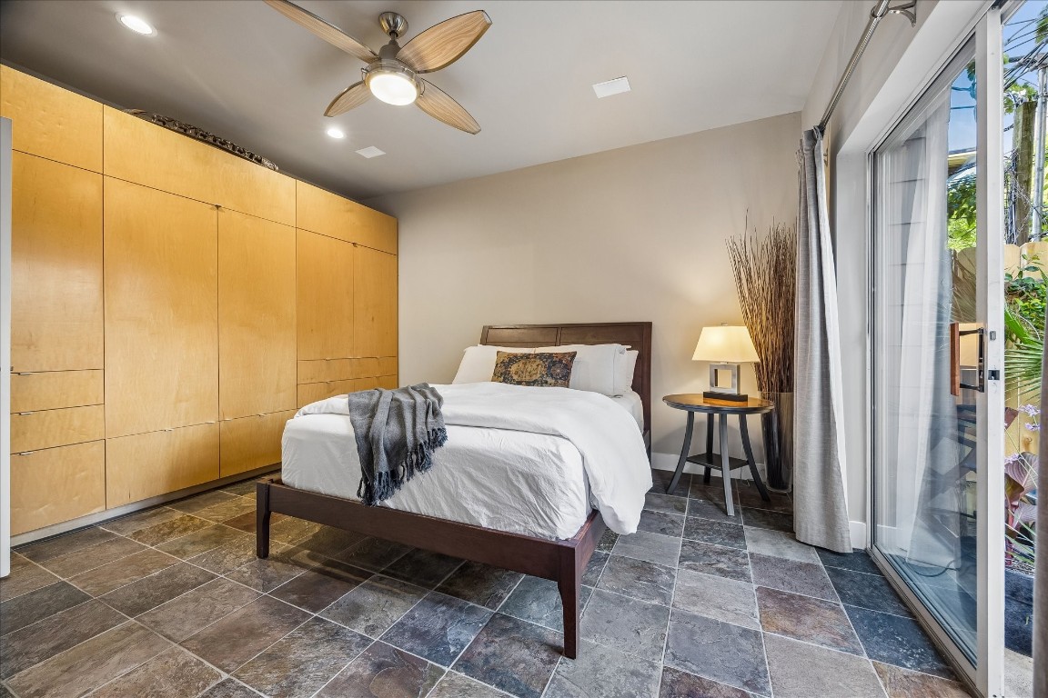 98 Drew Street, Unit A Houston, TX 77006 - Photo 7 of 38 a bedroom with a bed and a chandelier