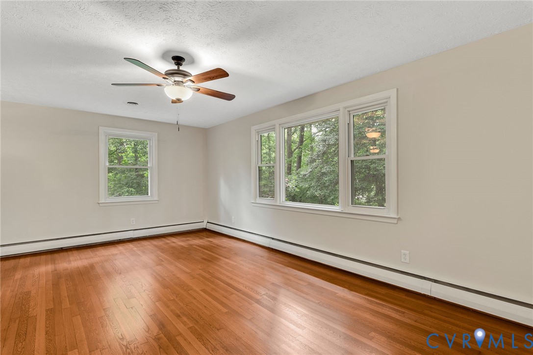 13101 Harrowgate Road Chester, VA 23831 - Photo 9 of 44 a view of an empty room with wooden floor and a window