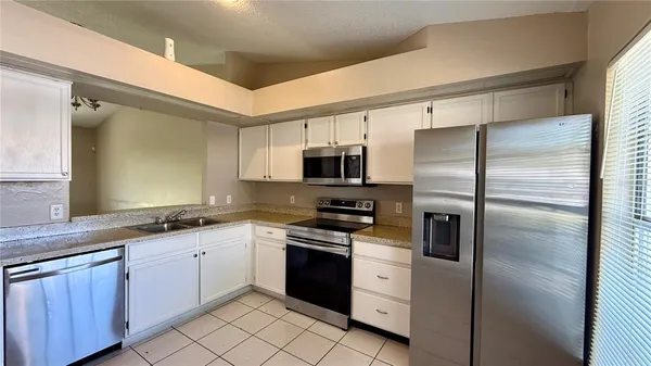 a kitchen with a sink stainless steel appliances and cabinets