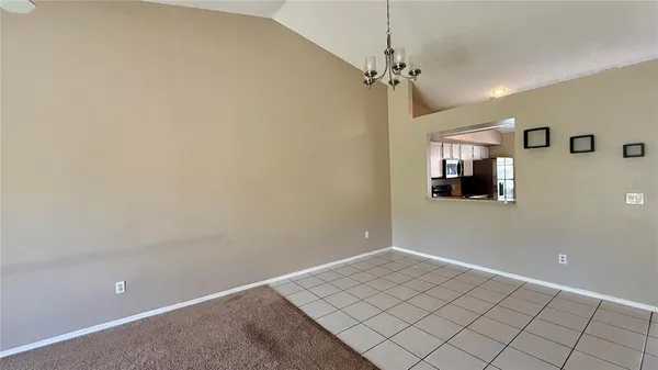 a view of a room with window and hardwood floor