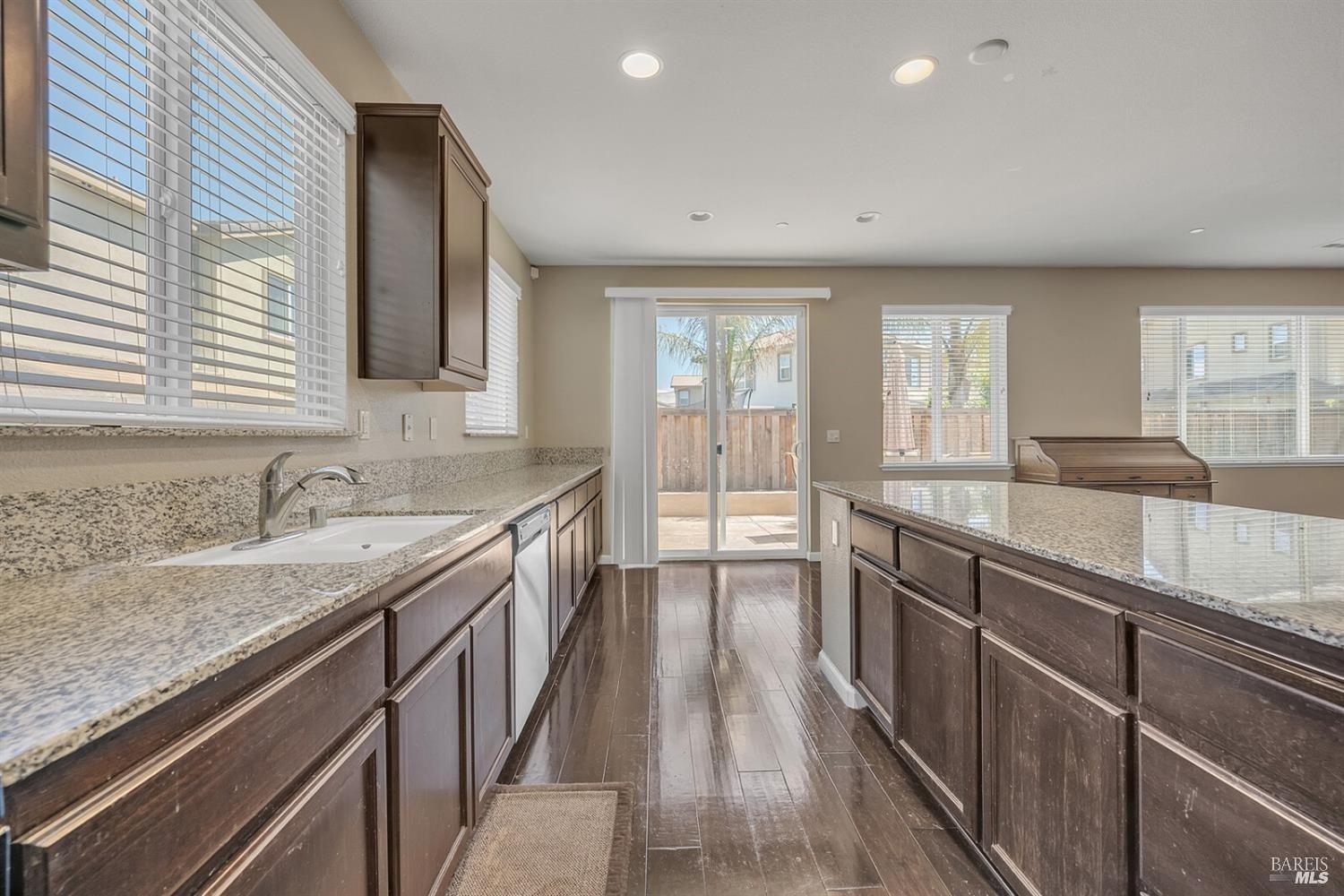526 Epic Street Vacaville, CA 95688 - Photo 11 of 39 a large kitchen with granite countertop a sink and dishwasher with a large window