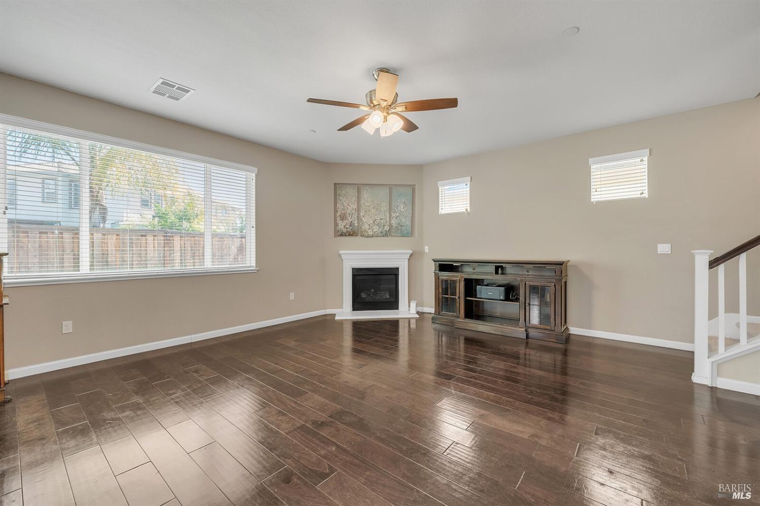 526 Epic Street Vacaville, CA 95688 - Photo 14 of 39 an empty room with wooden floor fireplace and windows