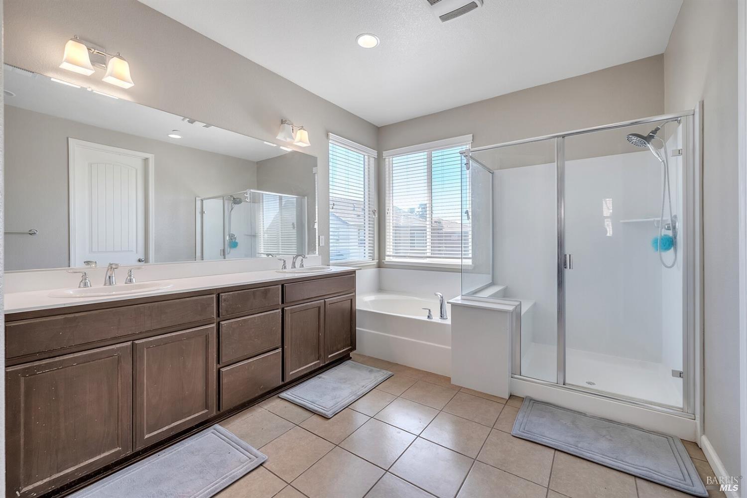 526 Epic Street Vacaville, CA 95688 - Photo 25 of 39 a large bathroom with a double vanity sink a large mirror and a shower