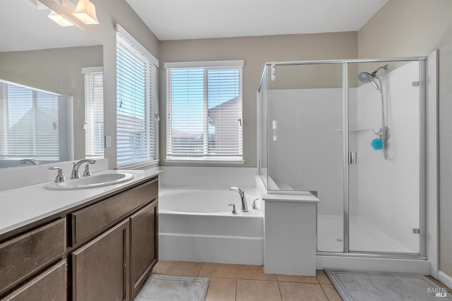 526 Epic Street Vacaville, CA 95688 - Photo 26 of 39 a bathroom with a tub sink and mirror