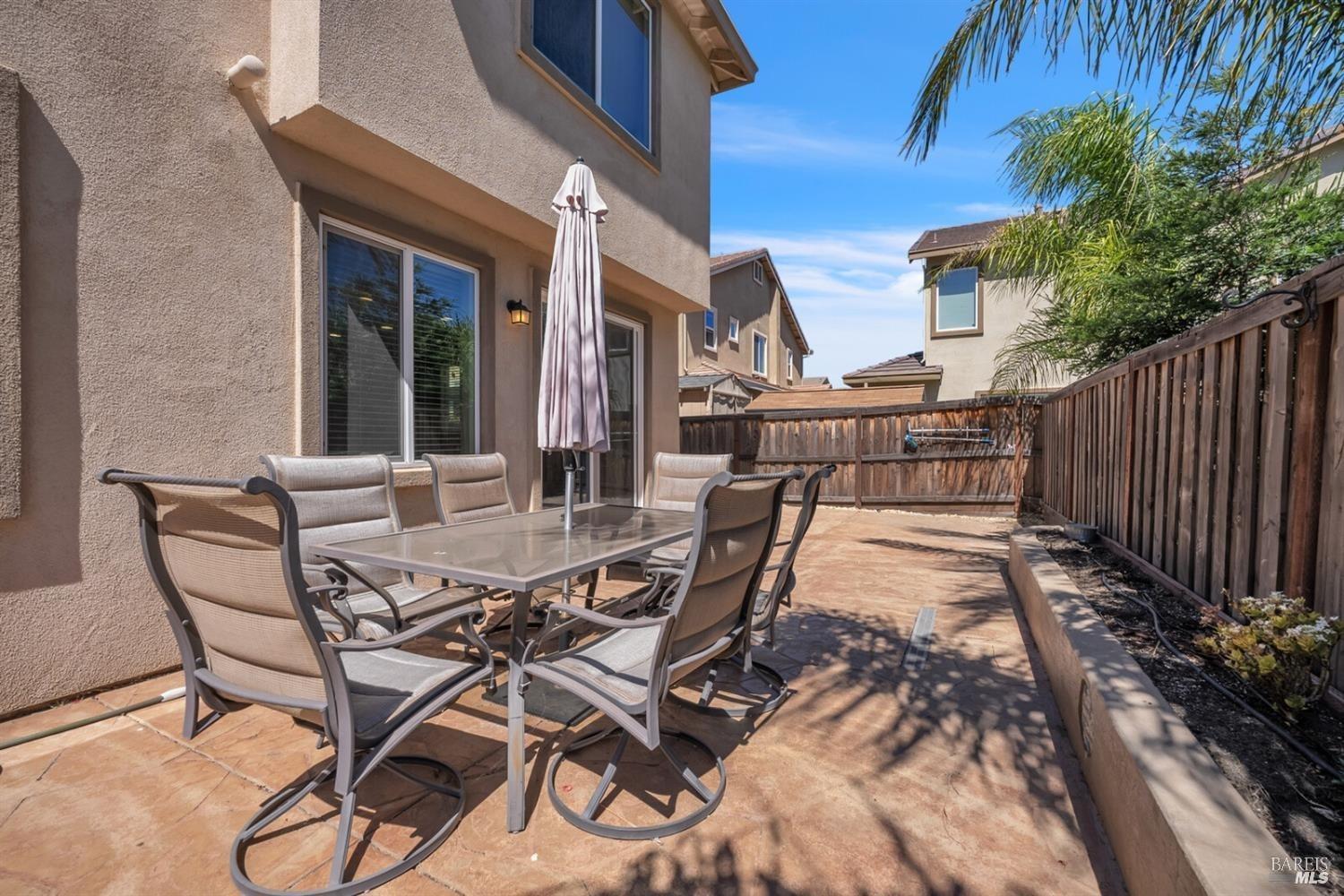 526 Epic Street Vacaville, CA 95688 - Photo 35 of 39 a view of a patio with table and chairs and wooden fence