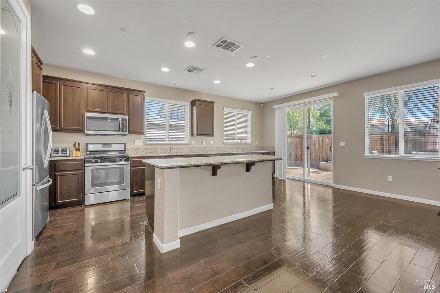 526 Epic Street Vacaville, CA 95688 - Photo 7 of 39 a kitchen with stainless steel appliances granite countertop a stove a sink and a refrigerator